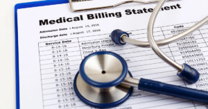 A medical billing statement with a blue stethoscope laying on top of it