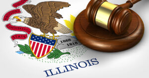 A wooden gavel sits atop the Illinois state flag