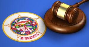 A wooden gavel sits atop the Minnesota state flag