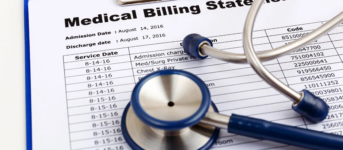 A medical billing statement with a blue stethoscope laying on top of it