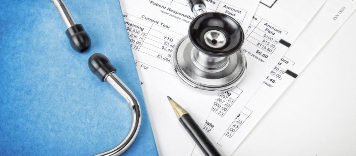 Medical bills with stethoscope